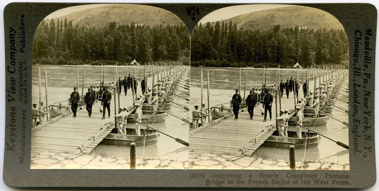 Horisontellt sepia -stereokort som visar uniformerade officerare som korsar en pontonbro med män som står i pontonerna på vardera sidan av bron. Keystone -stereografnummer 18079 av Keystone View Company