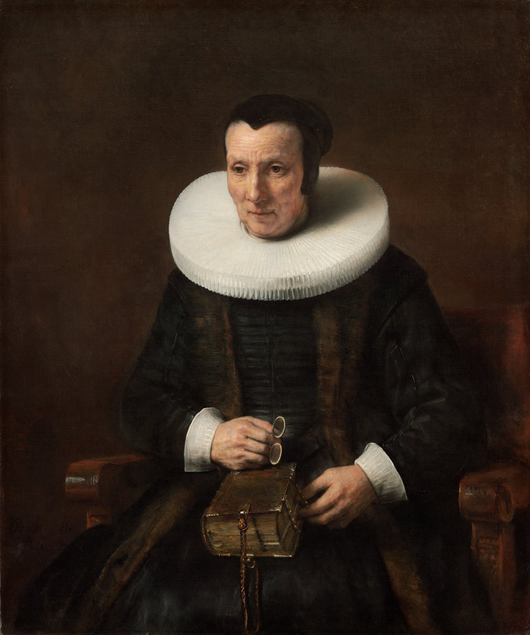 Gammal dam med en bok av Rembrandt van Rijn
