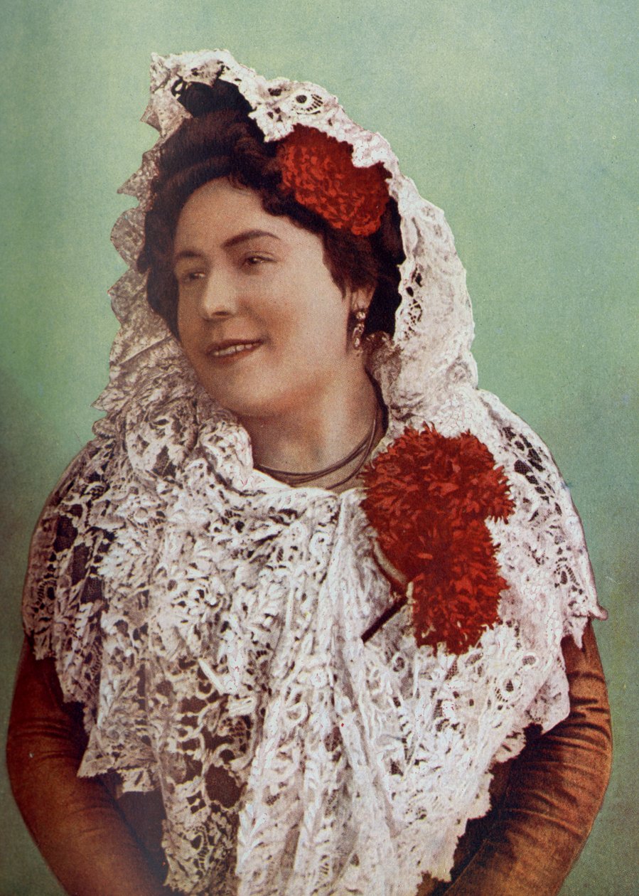 Spanien. Scharlakansröda blommor och vit spetsmantilja draperad över hår och axlar visar till fördel Andalusiens södra skönhet. 1920 av Unknown