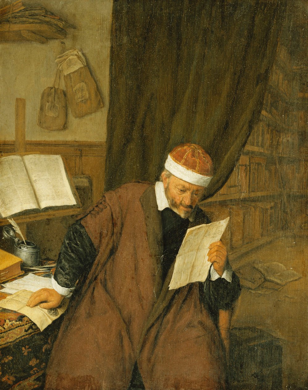 En advokat som sitter vid ett skrivbord och läser ett brev, ett bibliotek bortom, 1668 av Adriaen Jansz. van Ostade
