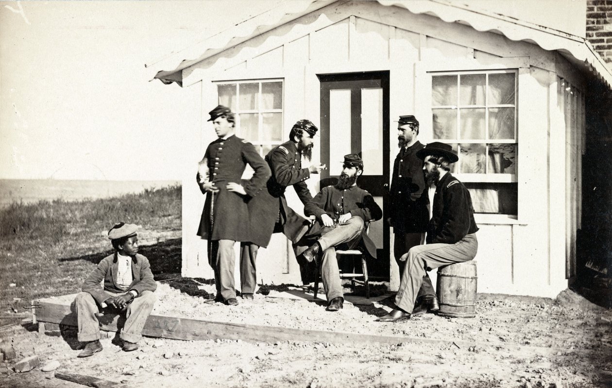 Fem soldater från inbördeskriget samlades på en veranda utanför hemmet, afroamerikanska ungdomar sittande nära dem, 1861-65 av American Photographer