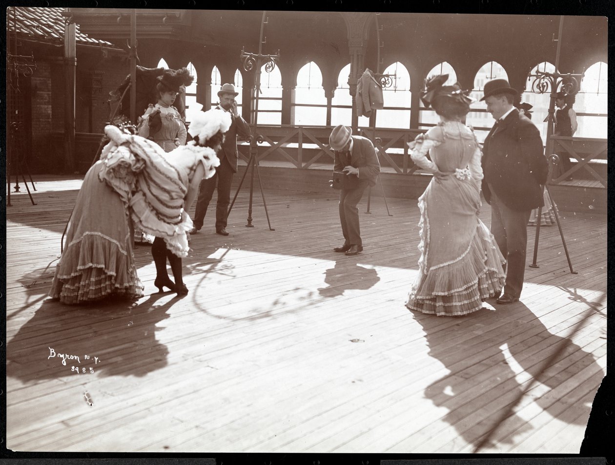 Fem skådespelerskor i kostym repeterar på taket av vad som förmodligen är New York Theatre, New York, 1900 (silvergelatintryck) av Byron Company