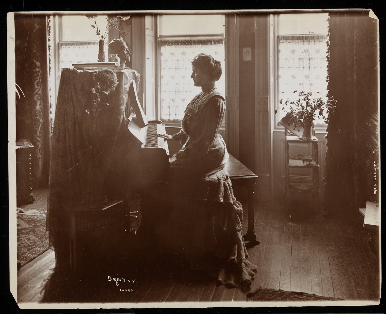 Porträtt av Mrs Elliott eller hennes kvinnliga släkting som spelar piano, 1902 (silvergelatintryck) av Byron Company