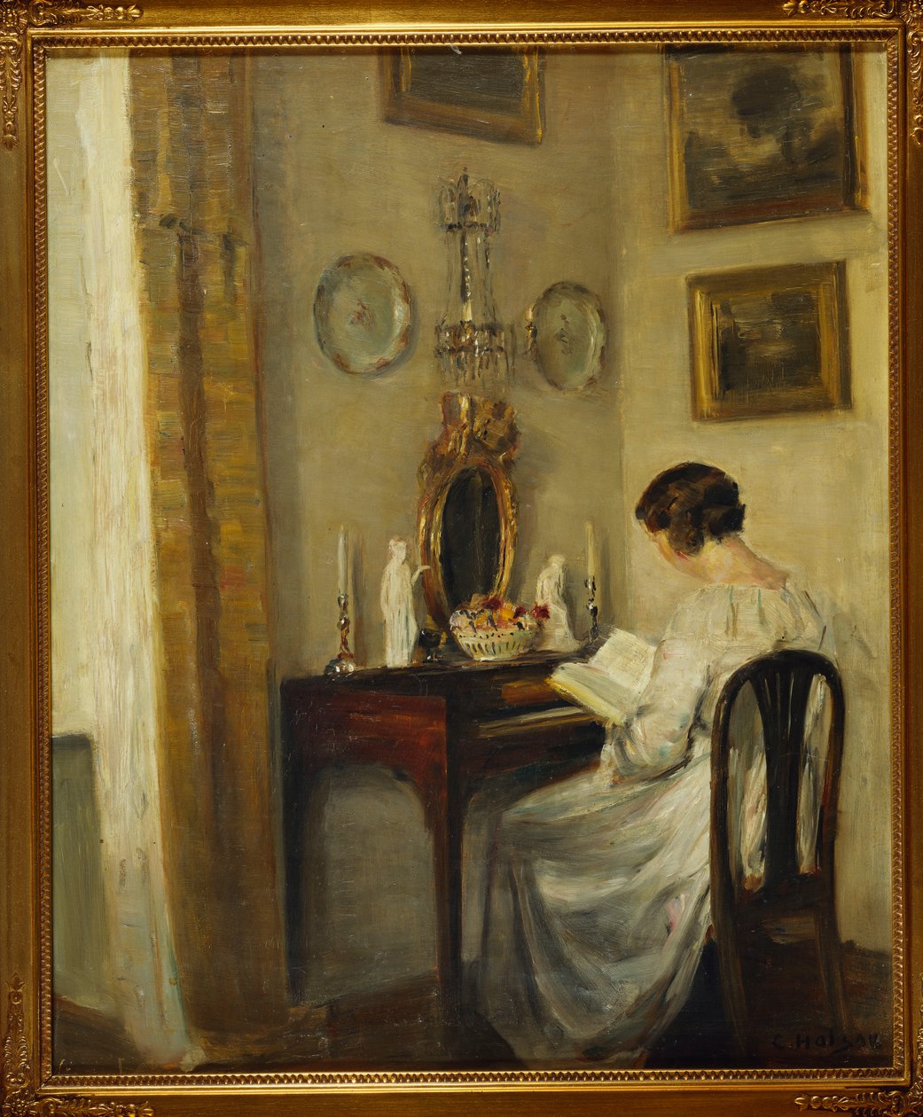 En interiör med en flicka som läser vid ett skrivbord (olja på duk) av Carl Holsoe