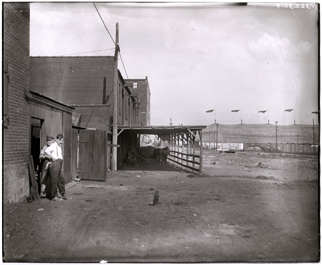 Commercial buildings or stables in front of the Barnum and Bailey circus tent at Grand and Laclede av Charles Clement Holt