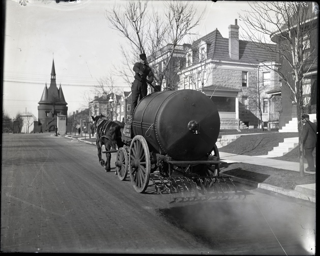 Street oiling truck at work on Washington Place near the entrance from Union Boulevard av Charles Clement Holt