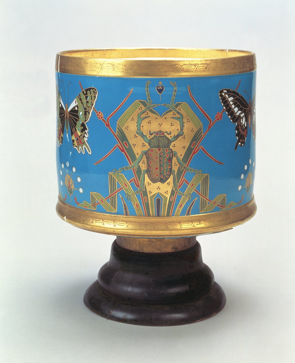 Jardiniere dekorerad i imitation av cloisonne med skalbaggar och fjärilar, Minton & Co., 1867 (porslin med träbas) av Christopher Dresser