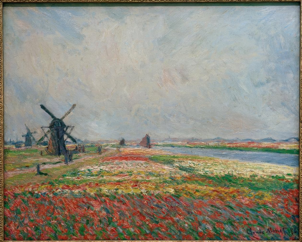 Fält av blommor och väderkvarnar nära Leiden av Claude Monet