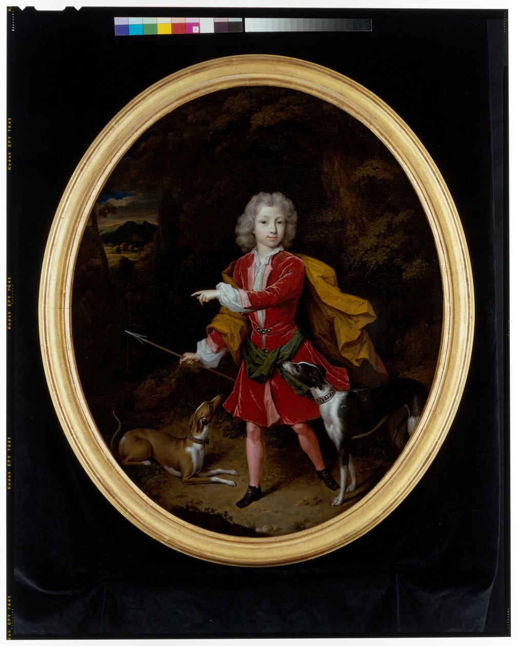 Ett porträtt av en ung man med ett par jakthundar i ett skogslandskap av Constantin Netscher