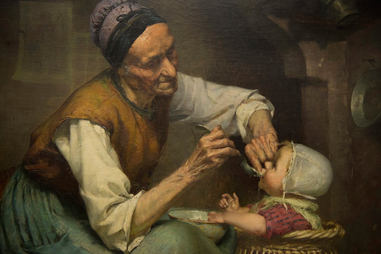 En gammal kvinna matar sitt barnbarn i en flätad gåstol av Edouard Jerome Paupion av Edouard Jerome Paupion