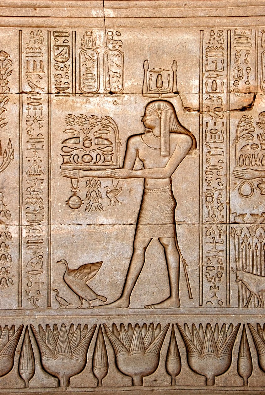 Egyptisk antikvitet: representation av en man som ger offer till gudinnan, Hathortemplet, Denderah, Egypten - egyptisk civilisation: en man som bär offergåvor till gudinnan Hathor, ristad på väggen av Hathortemplet (eller Tentyratemplet) i Denderah av Egyptian Ptolemaic Period