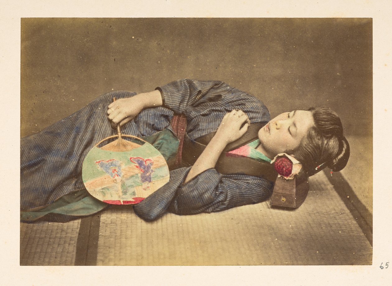 Japansk kvinna sover, Tre fjärdedels studioporträtt av en ung japansk kvinna som sover, håller en fläkt i höger hand och med huvudet vilande på en träkudde,   Fotograf: Okänd  Lucas Collection: Fotografisk rekord av världen t av English Photographer