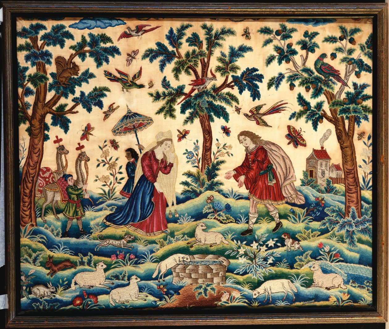 En fin handarbetsbild broderad i ull och siden, troligen föreställande Jakobs och Rakels möte vid brunnen av English School