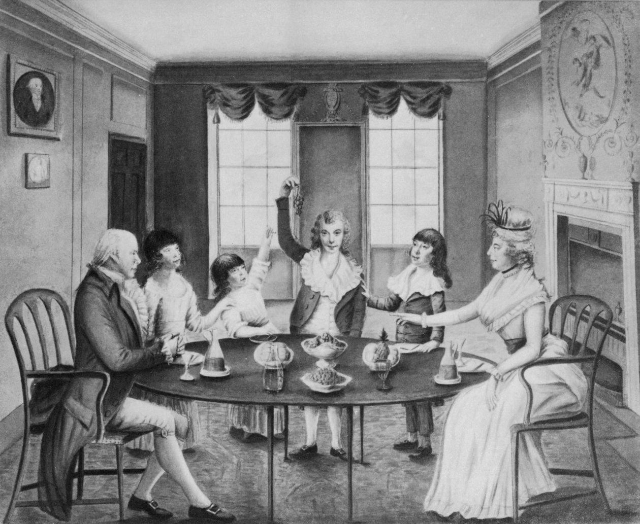 En interiör med en dam och en herre vid ett bord med sina fyra barn stående bakom det, ca 1780 av English School