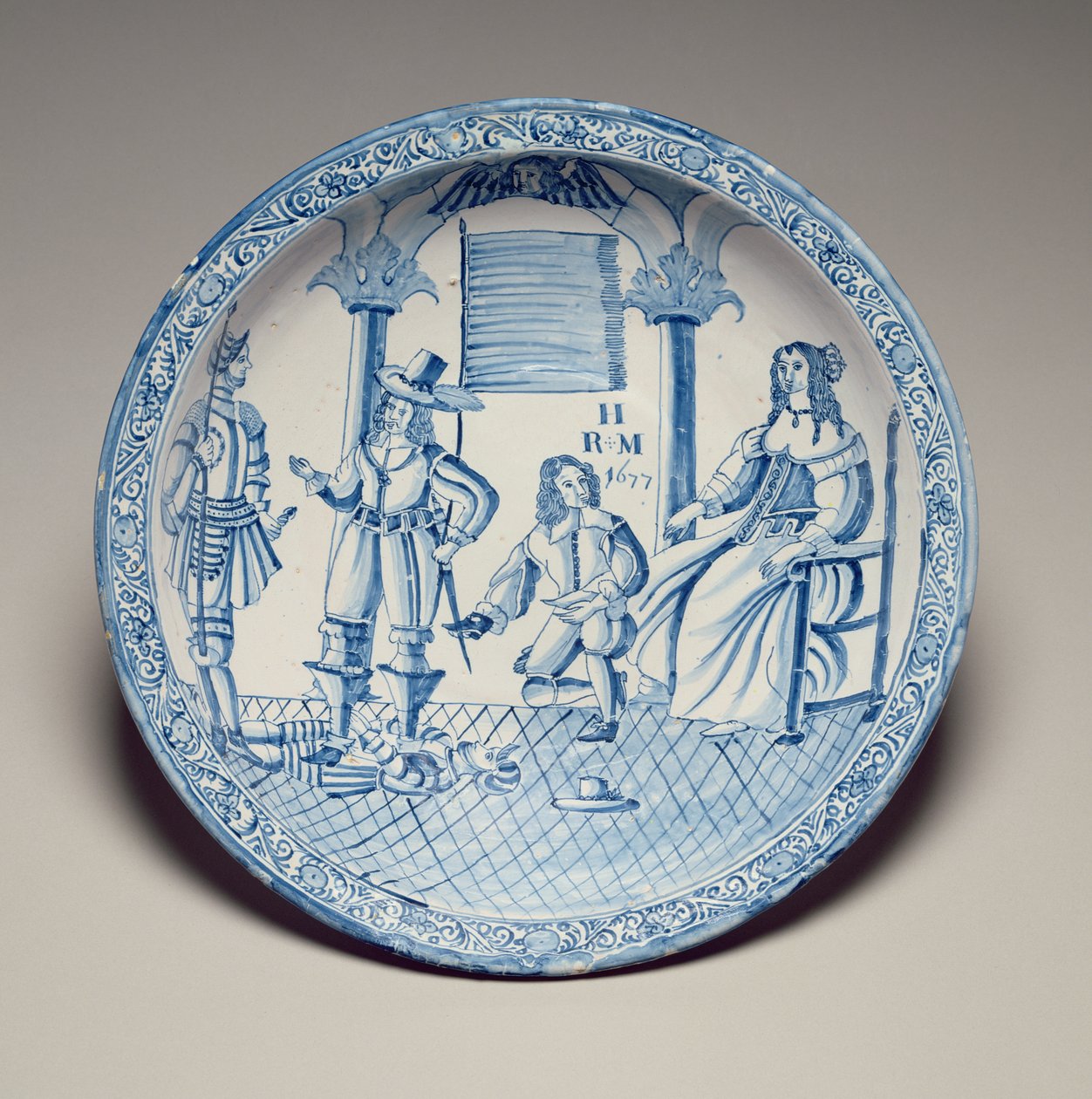 Fat med drottning Catherine sittande med en sko monterad av en knästående kavaljer, 1677 (tennglaserat lergods) av English School