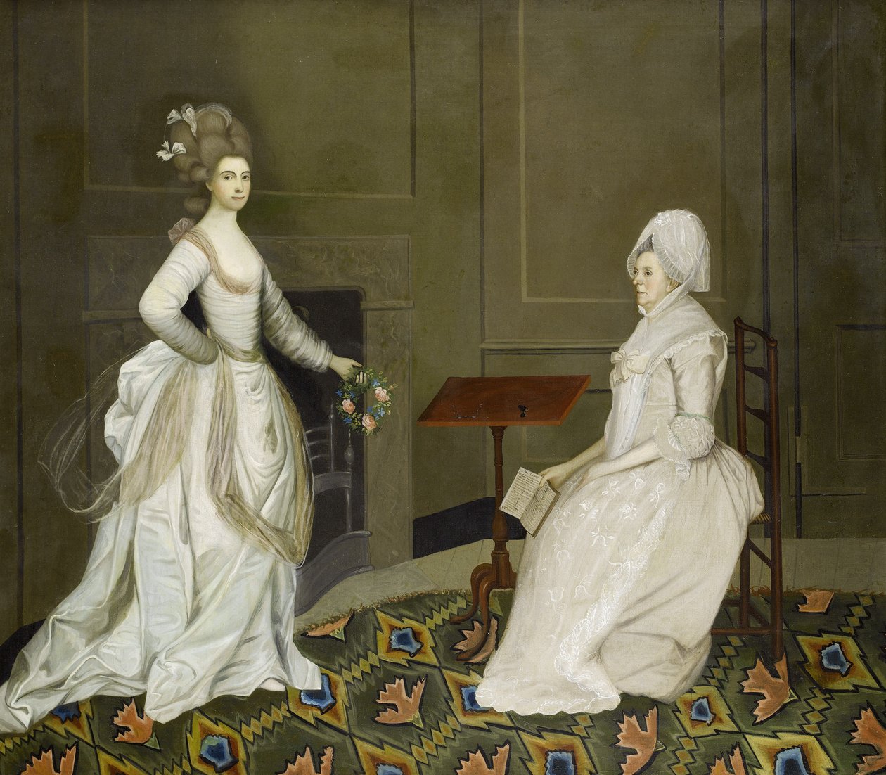 Två damer i en interiör, en läser, den andra håller i en krans av blommor av English School, 18th Century