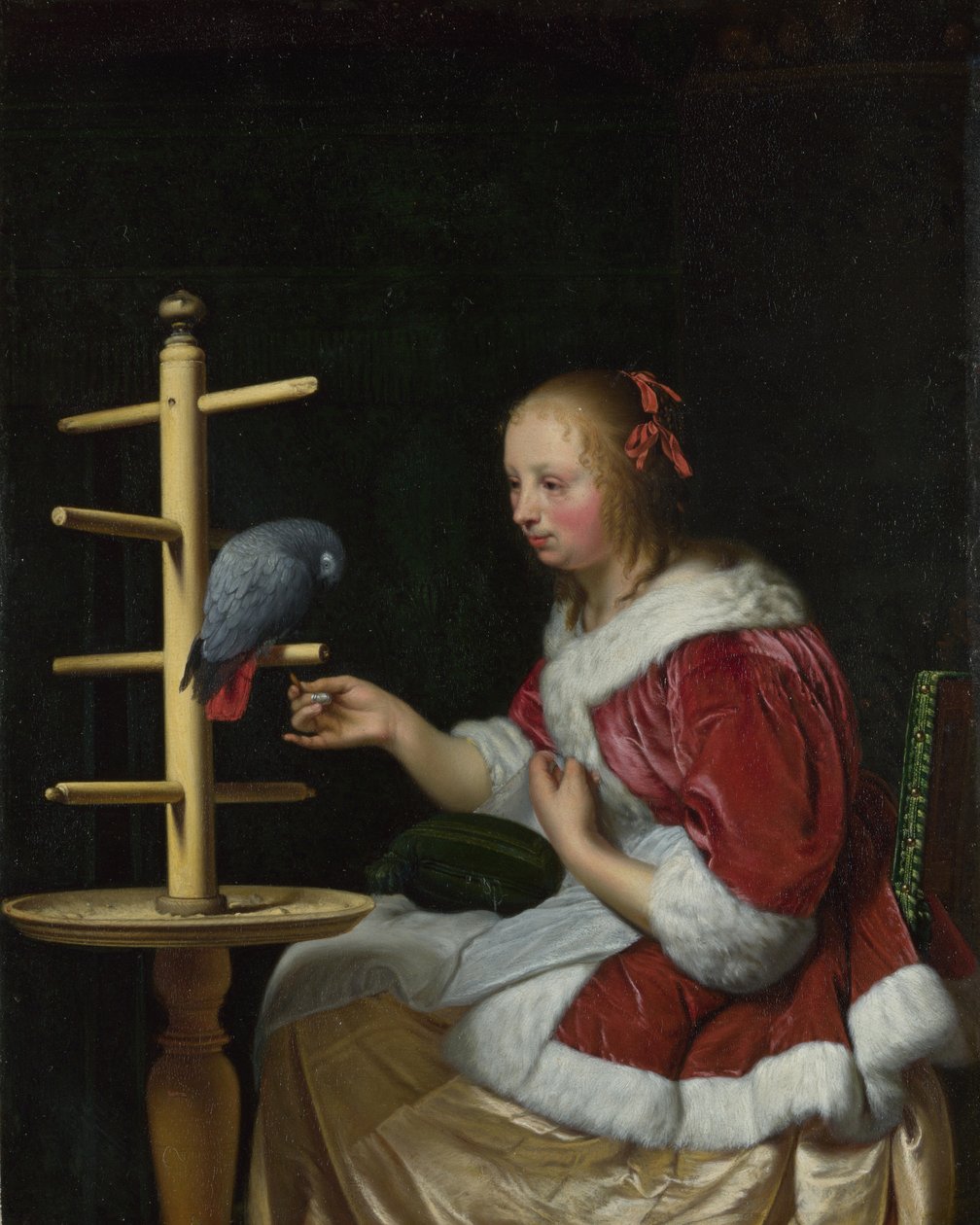En kvinna i en röd jacka matar en papegoja, ca 1663 av Frans van Mieris the Elder