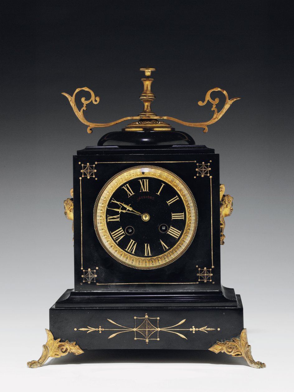 En mantelklocka av svart kompositionssten, med inskuren dekor, med ben, finials och beslag i förgylld mässing, av Jausions of Pau, Frankrike, ca 1876-78 av French School