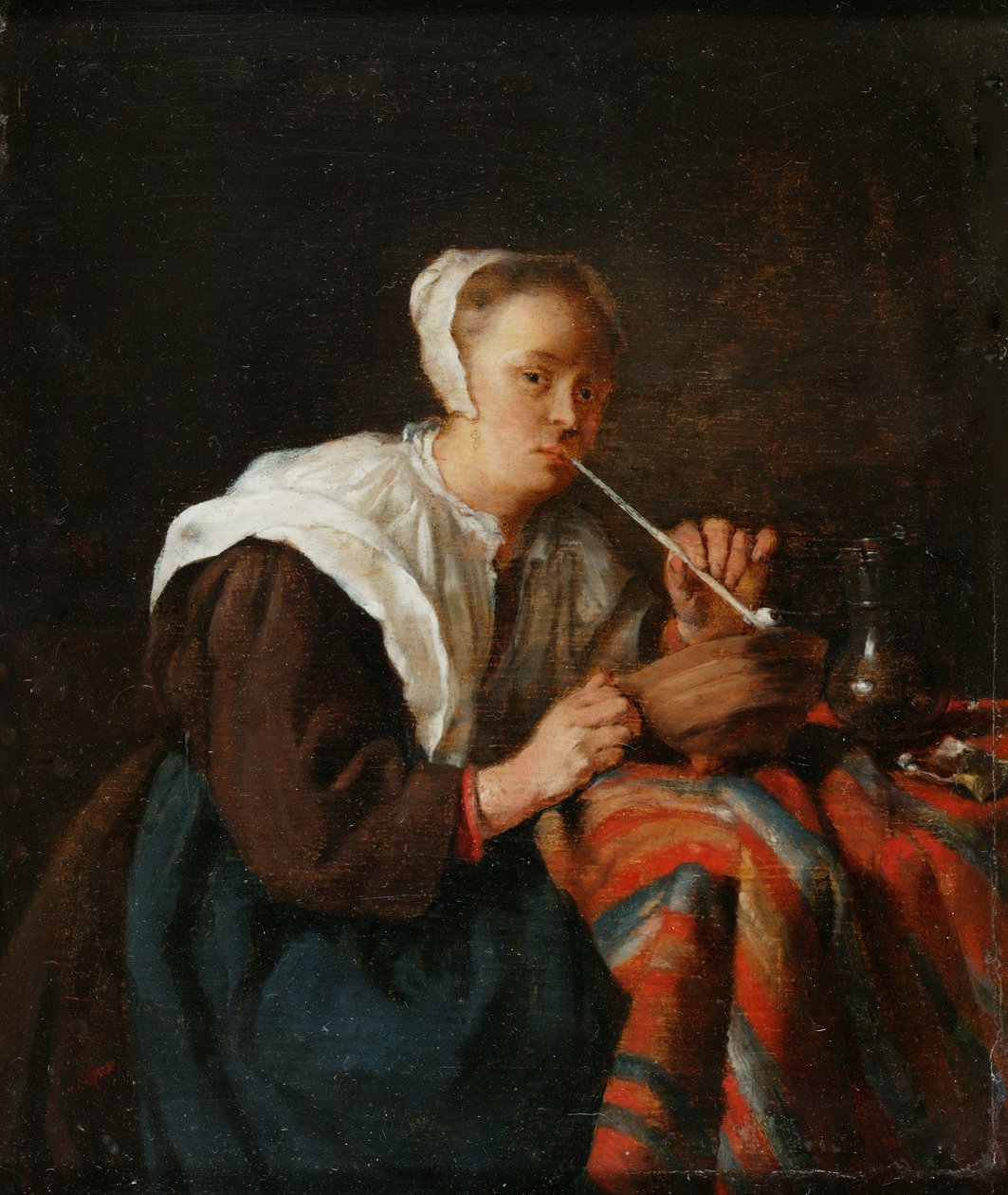 En kvinna sitter och röker pipa (olja på panel) av Gabriel (after) Metsu