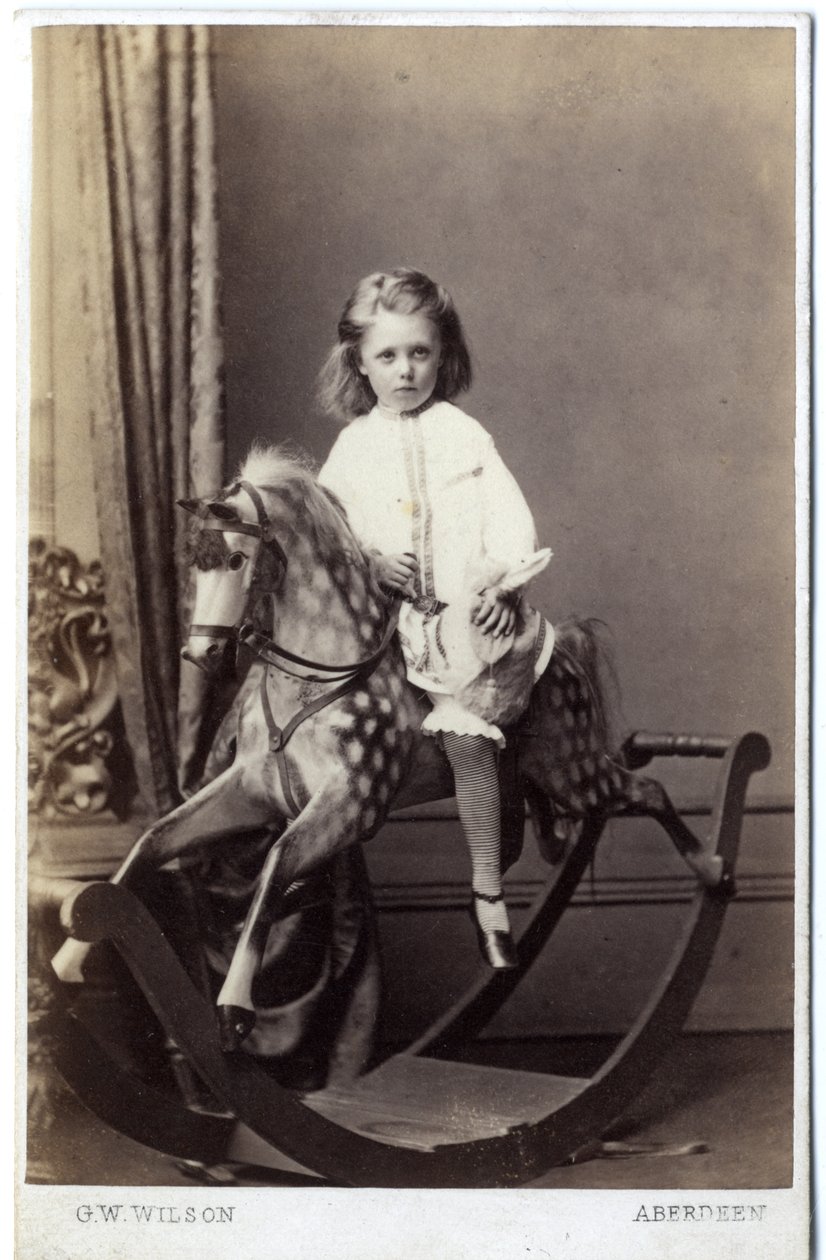 Ung flicka sitter på en gunghäst, 1860-tal (albumintryck) av George Washington Wilson