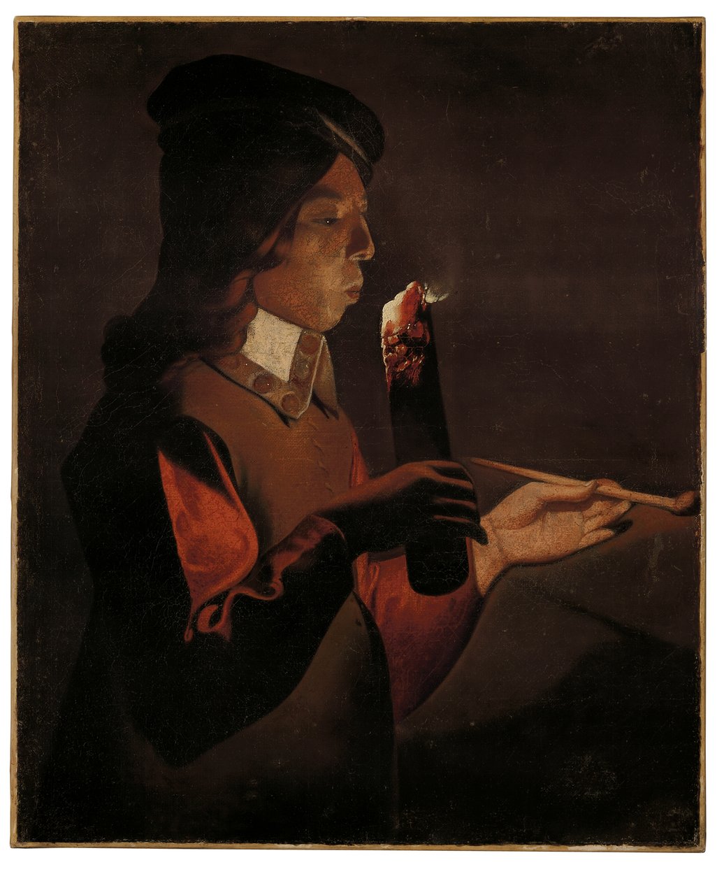 En ung pojke med en pipa som blåser på en brandbrand (olja på duk) av Georges de La Tour