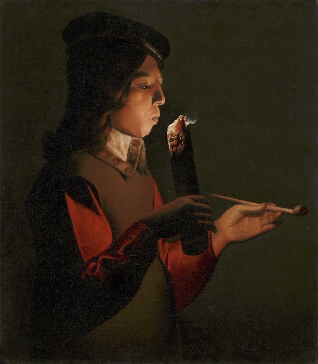 En ung pojke med en pipa, som blåser på en brandbrand, av La Tour, Georges, de (1583-1652). olja på duk av Georges de La Tour