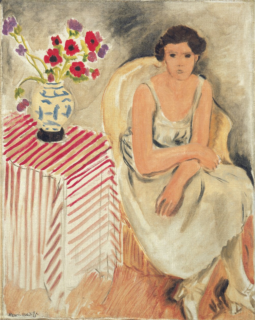 Kvinna på en stol - Blommor på bordet, eller nejlikor av Henri Matisse