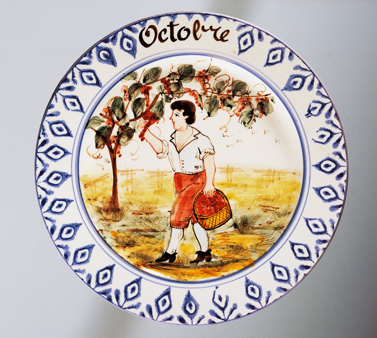 Tallrik föreställande månader, oktober, lergods, tillverkning Nove di Bassano, Veneto-regionen, Italien, 1900-tal. av Italian School