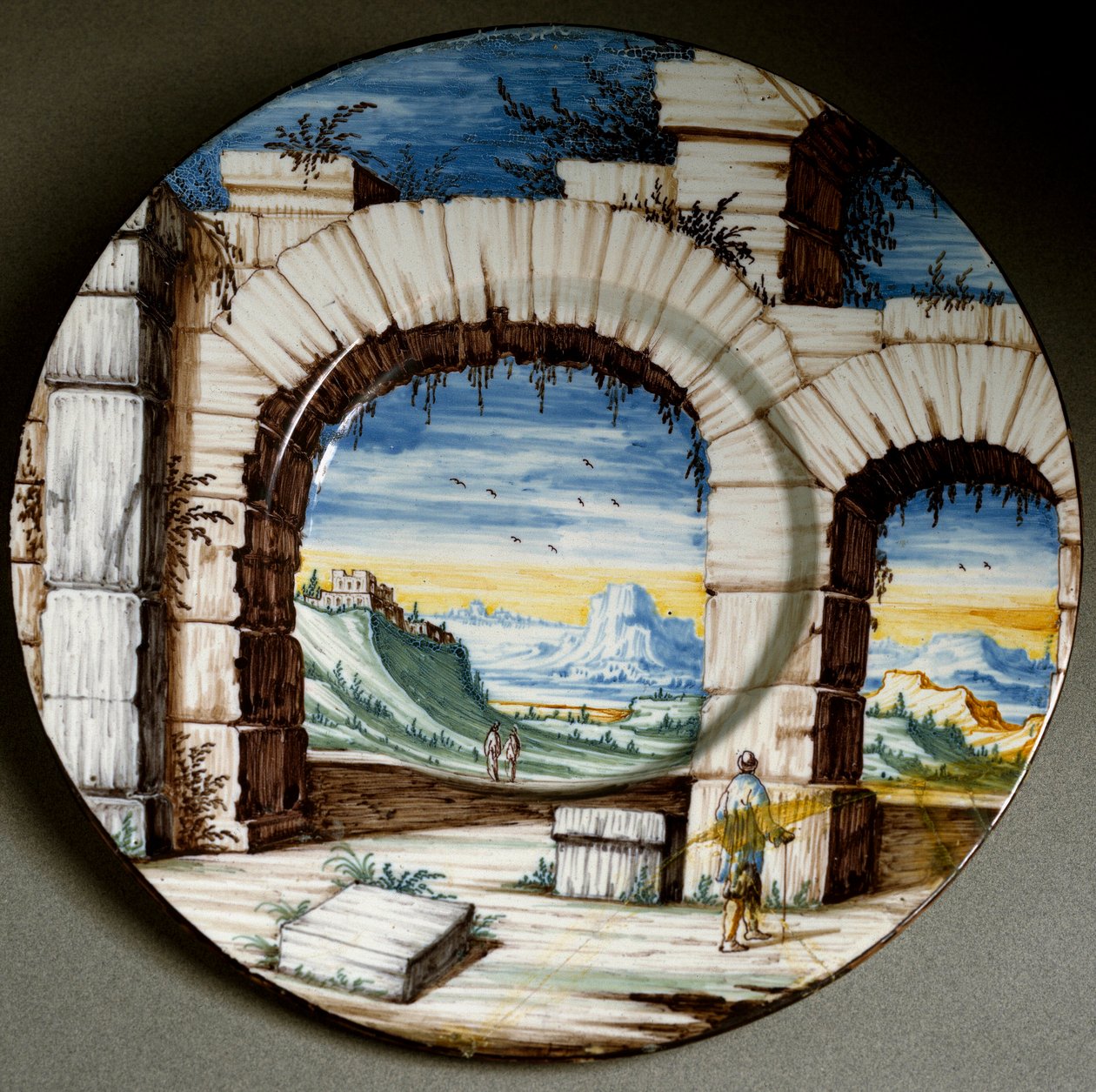 Ruin och landskap. Keramisk platta tillverkad i Angarano, Italien. Omkring 1650 Florens, Museo Nazionale del Bargello av Italian School