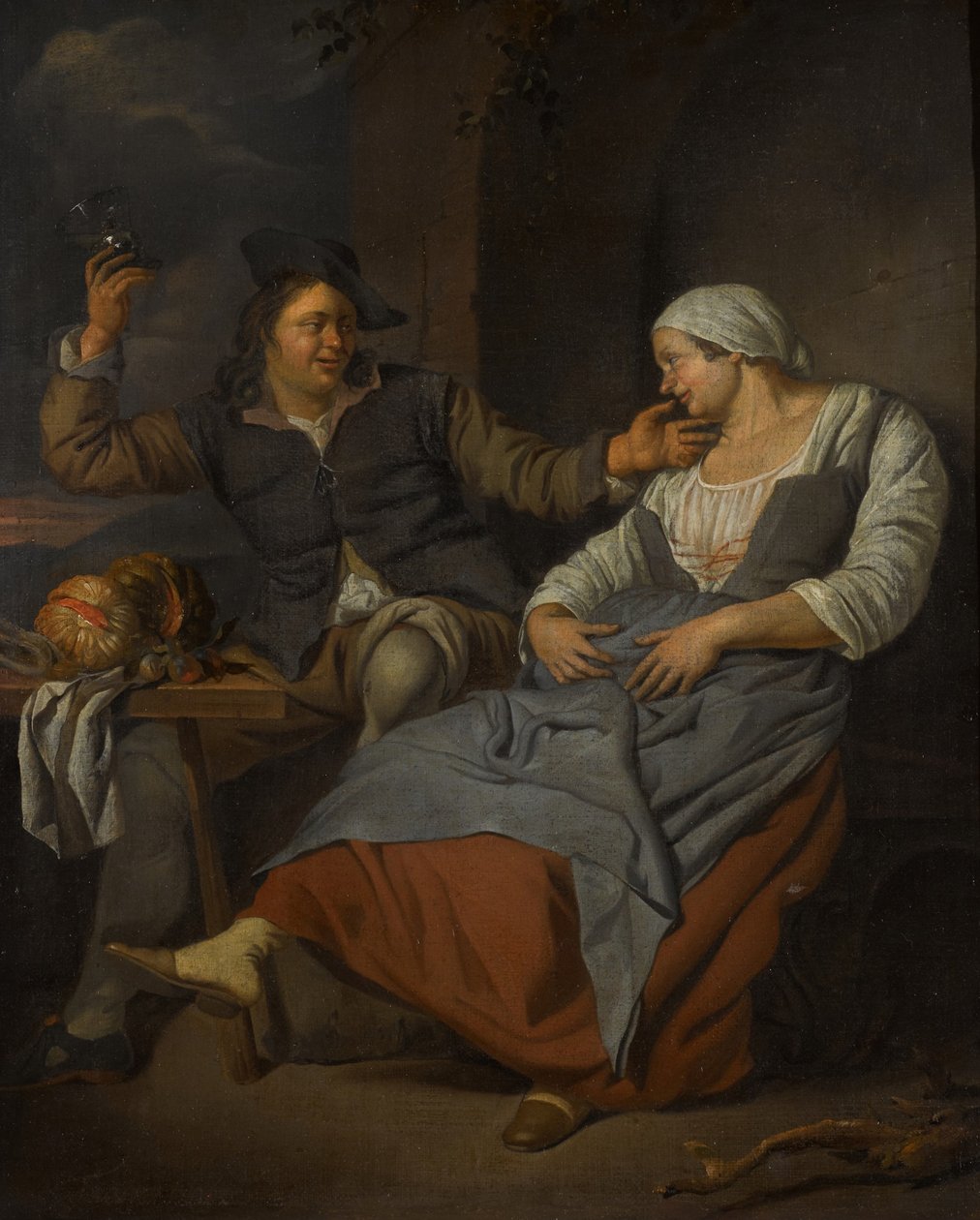 Ett sittande par som dricker vin av Jacob Toorenvliet