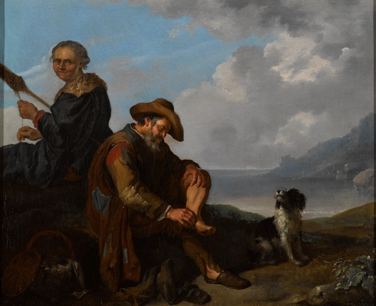 Ett sydligt kustlandskap med ett par figurer och en hund av Jacob Toorenvliet
