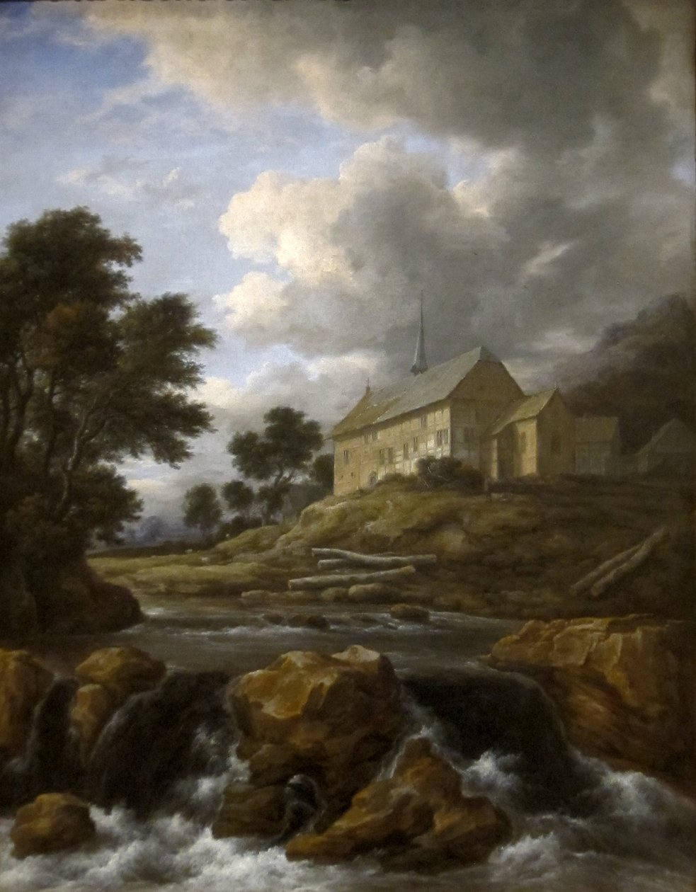 Landskap med en kyrka vid en torrent av Jacob van Ruisdael