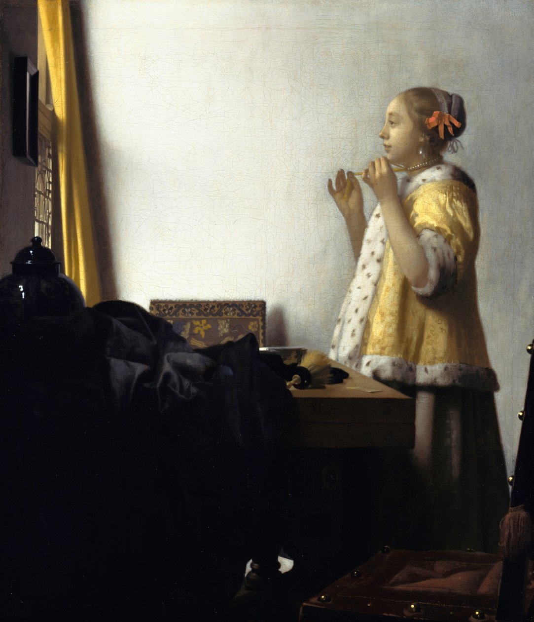 Ung kvinna med ett pärlhalsband av Jan Vermeer van Delft