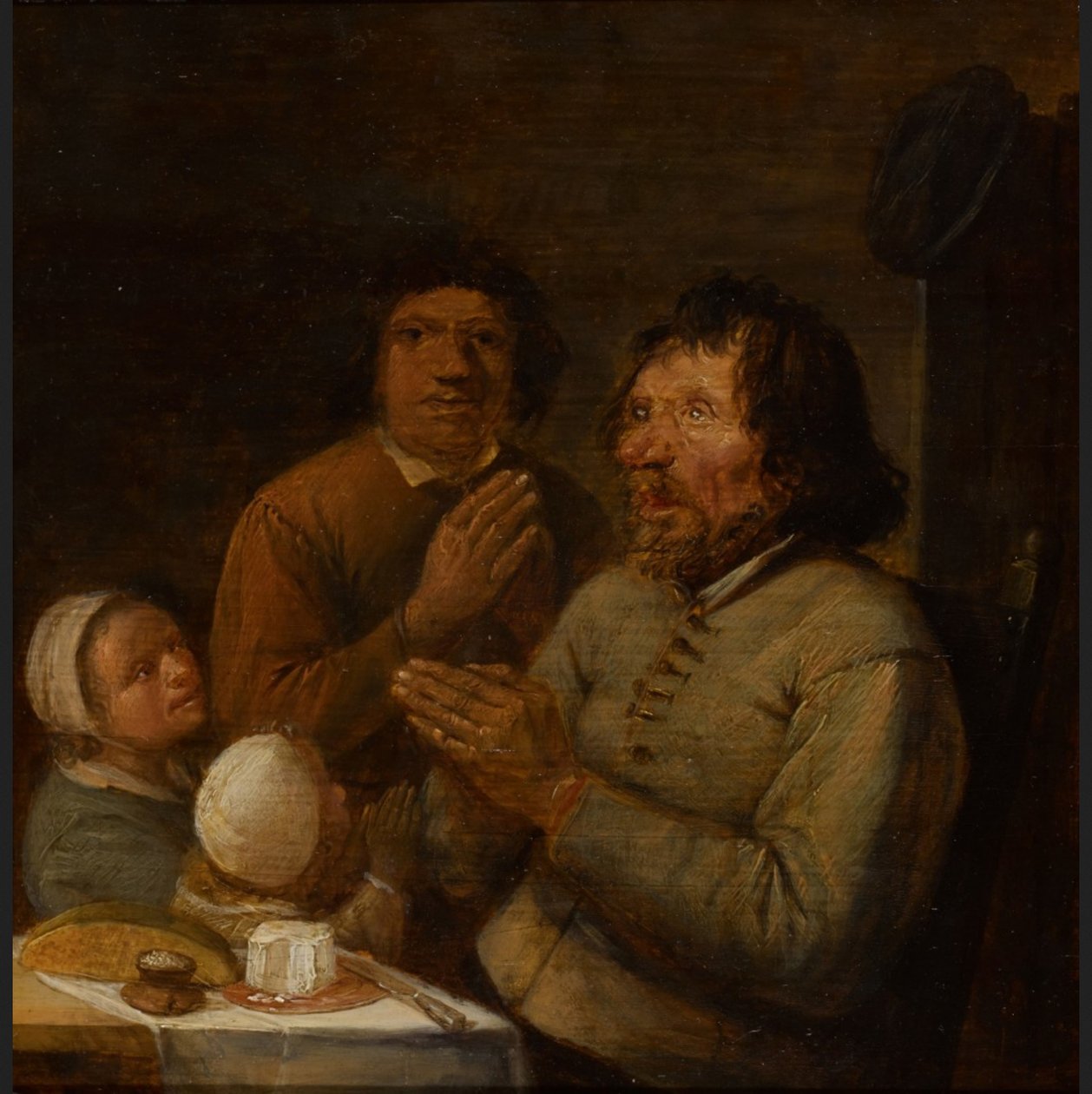 Interiör med en bondefamilj som ber av Joos van Craesbeeck