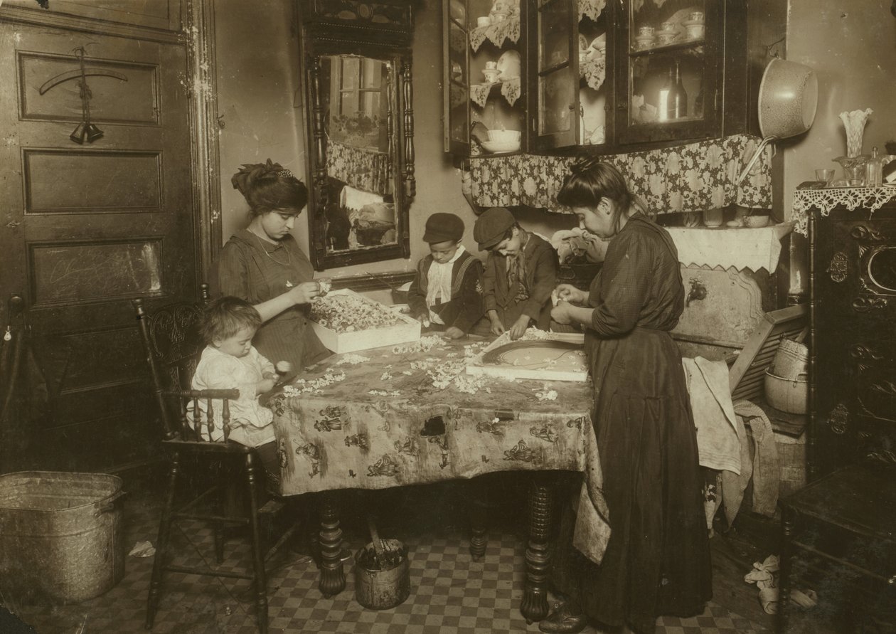 Mrs Mette och hennes barn (Josephine 13, Nicholas 6 och Johnnie 8 som tillsammans tjänar endast 40-50 cent per dag) gör blommor i en smutsig hyresrätt i New York, 1911. av Lewis Wickes Hine
