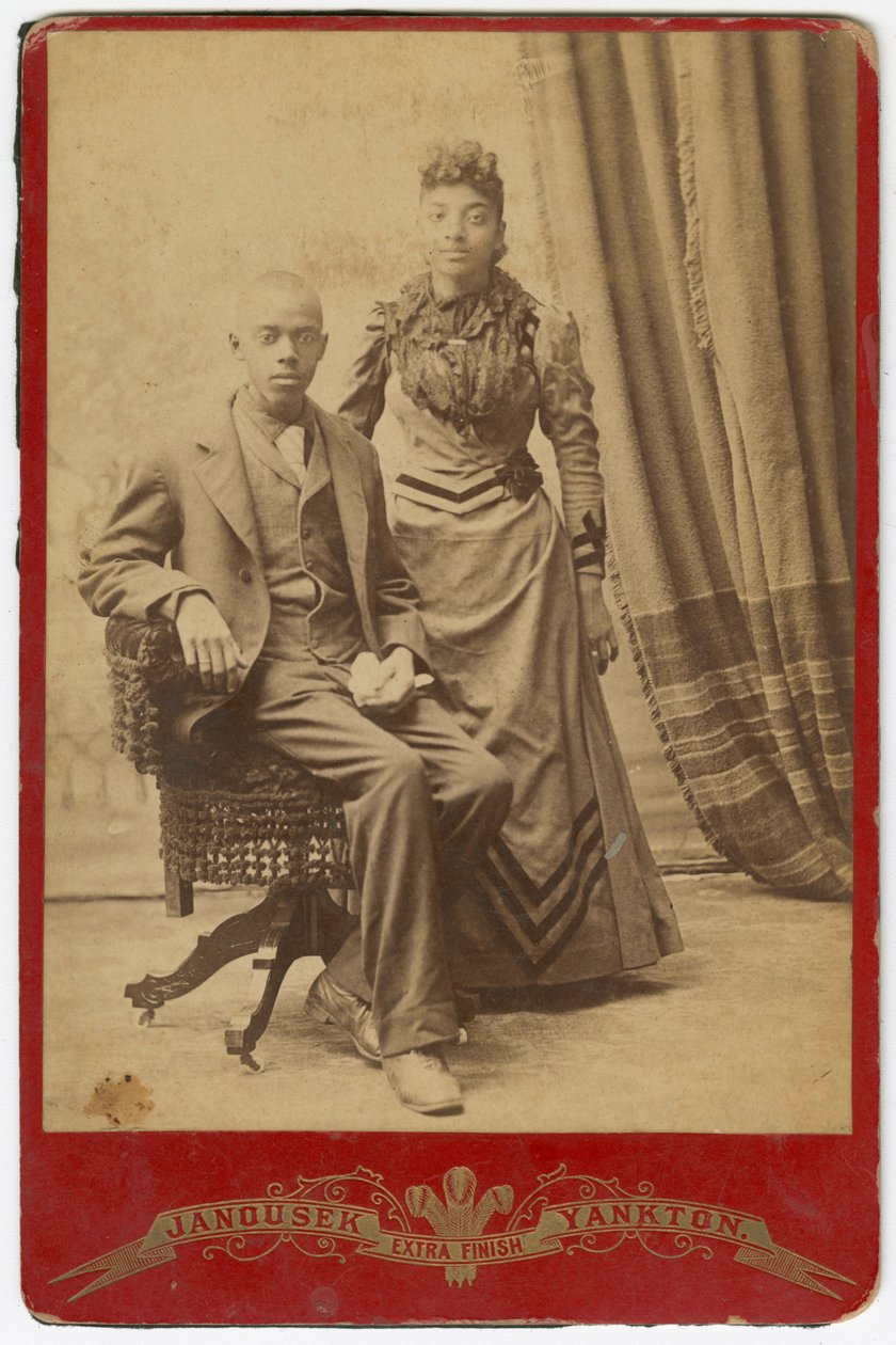 Fotografi av afroamerikansk man och kvinna i formella kläder, sent 1800-tal. av Louis Janousek