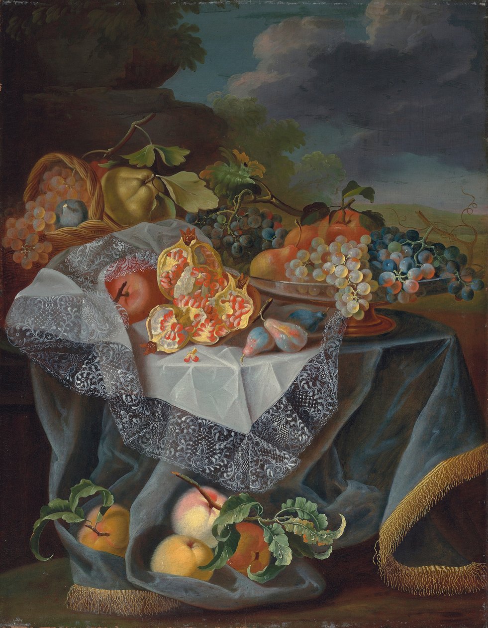 Vindruvor, päron och ett äpple på ett glaskärl, granatäpplen och en vävd korg med frukt på ett draperat bord och ett parklandskap bortom av Maximilian Pfeiler or Pfeiller