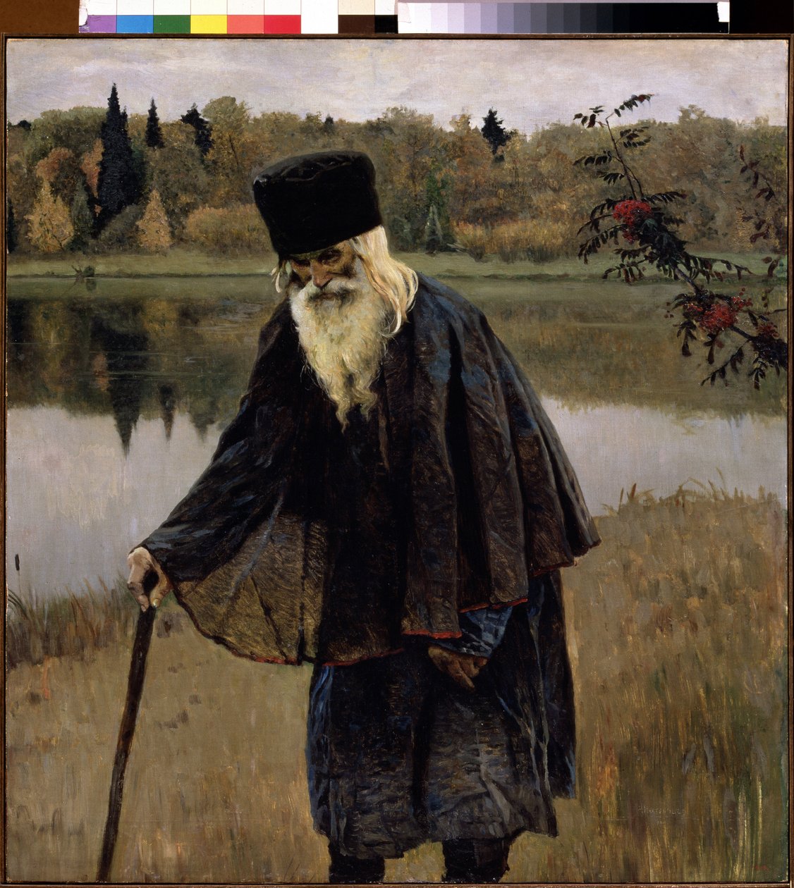 En eremit (En eremit). En gammal man, med skägg och vitt hår, går, böjd över käppen, på stranden av en sjö. Målning av Mikhail Vasilyevich Nesterov (1862-1942), olja på duk av Mikhail Vasilievich Nesterov