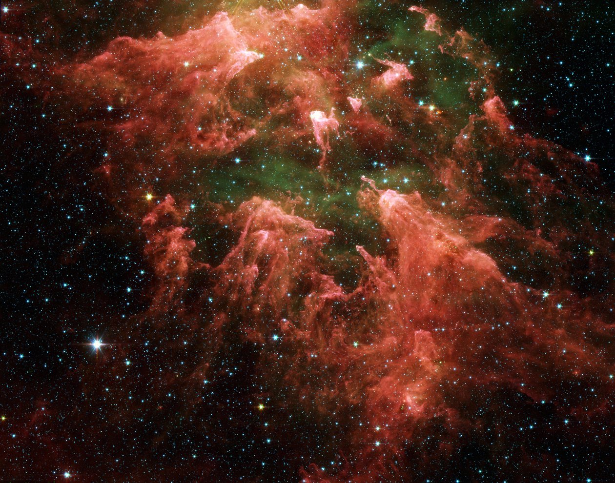 Spitzer Space Telescope bild i falsk färg av södra pelarområdet i den tsarbildande regionen som kallas Carina-nebulosan. Stjärnembryon (gula eller vita) inuti fingerliknande pelare av tjockt damm (rosa). Het g av National Aeronautics and Space Administration National Aeronautics and Space Administration