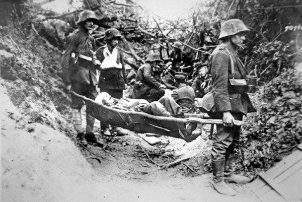 Tyska soldater från första världskriget som bär en sårad kamrat i en improviserad bår nära Soissons, juni 1918 (s/v foto) av Photographer German