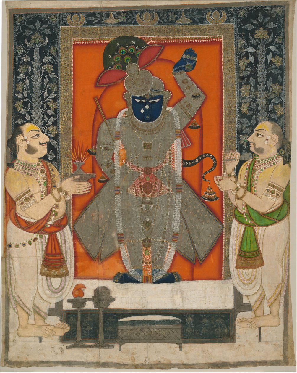 Präster som dyrkar Krishna som Shrinathji för Mountain of Food-festivalen [Annakuta utsava]; helgedom hängande [pichhavai] av Rajasthan Kota school