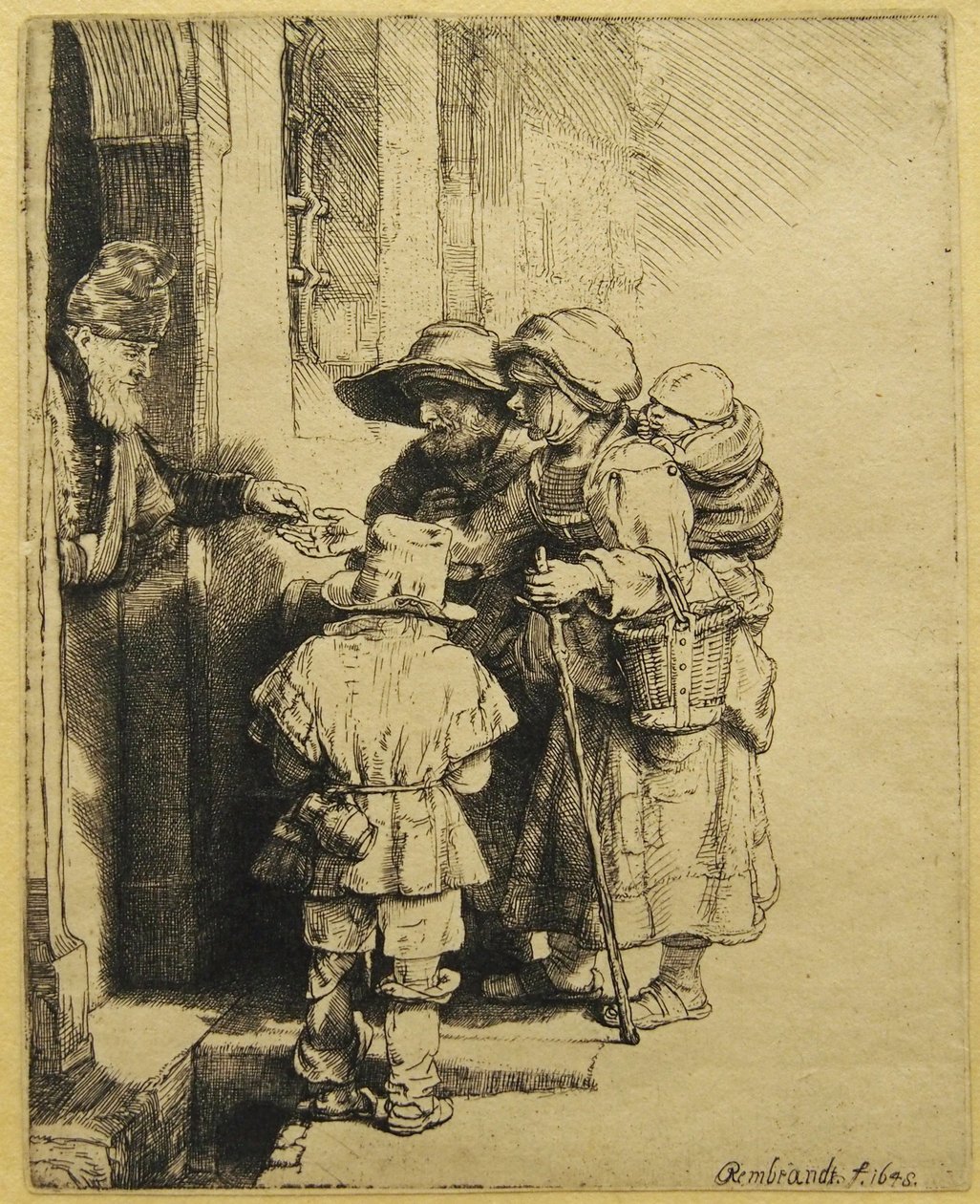 En blind, robust, robust spelare och familj som tar emot allmosor av Rembrandt van Rijn