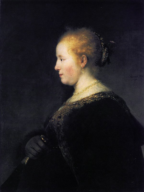 A young woman in profile with a fan av Rembrandt van Rijn