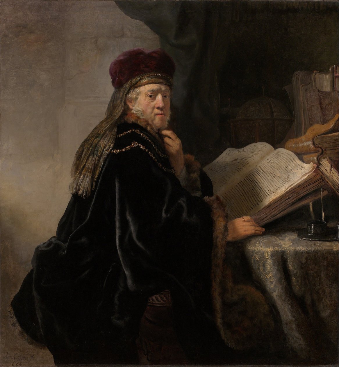 En forskare som sitter vid en skrivbordsforskare vid sin studie av Rembrandt van Rijn