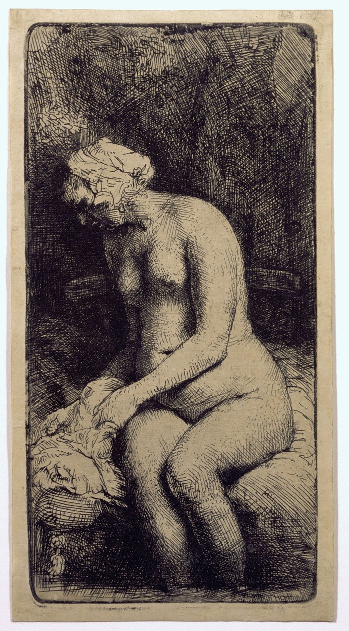 En kvinna som badar sina fötter vid en bäck av Rembrandt van Rijn
