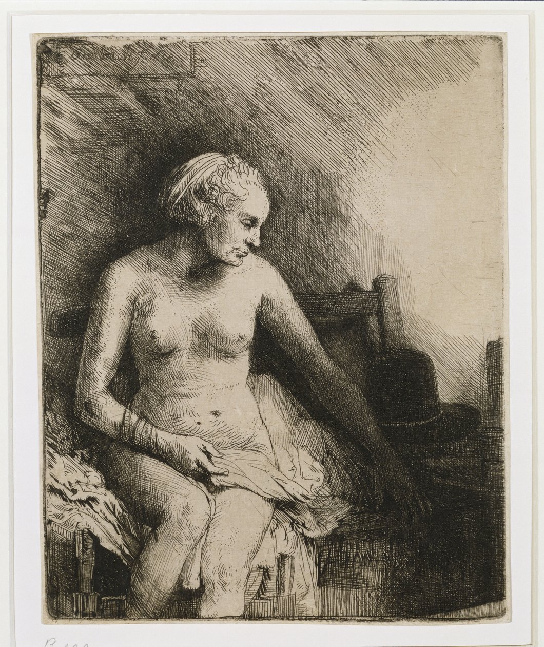 En kvinna vid badet med en hatt bredvid sig, 1658 av Rembrandt van Rijn