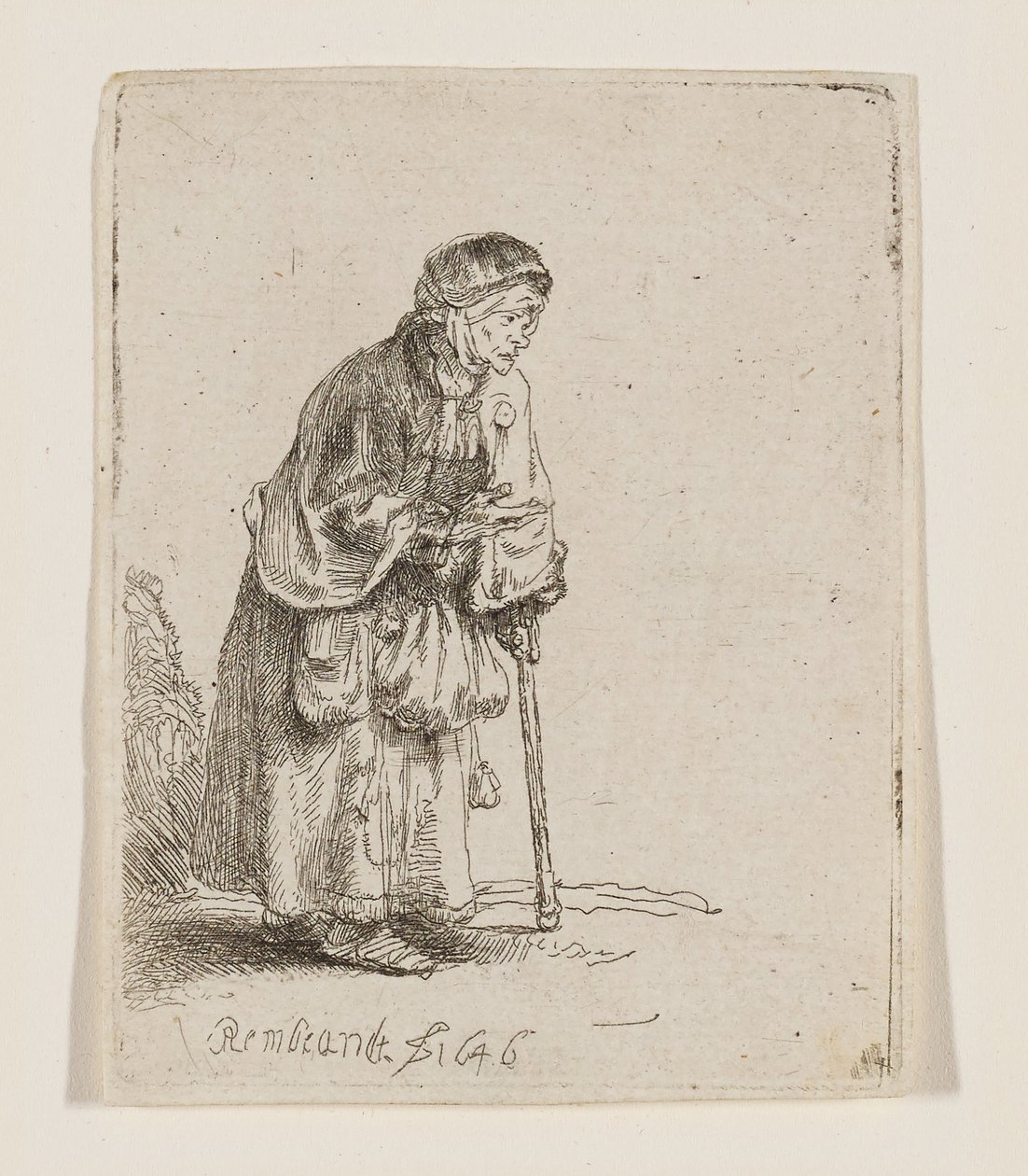 Tiggarkvinna lutad mot en käpp av Rembrandt van Rijn