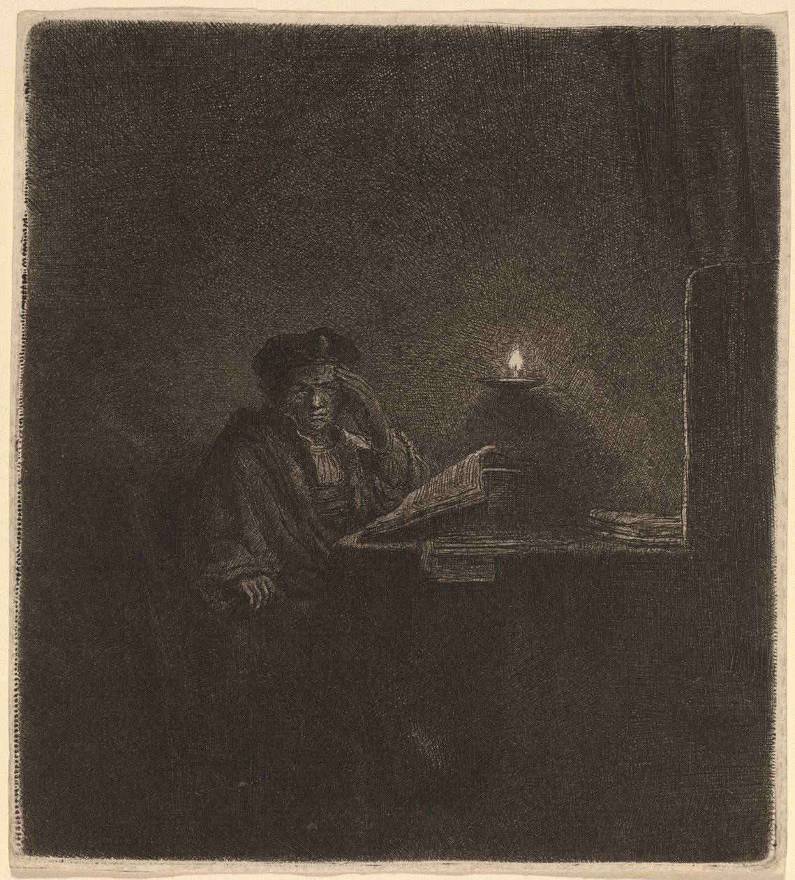 Student vid ett bord vid levande ljus av Rembrandt van Rijn