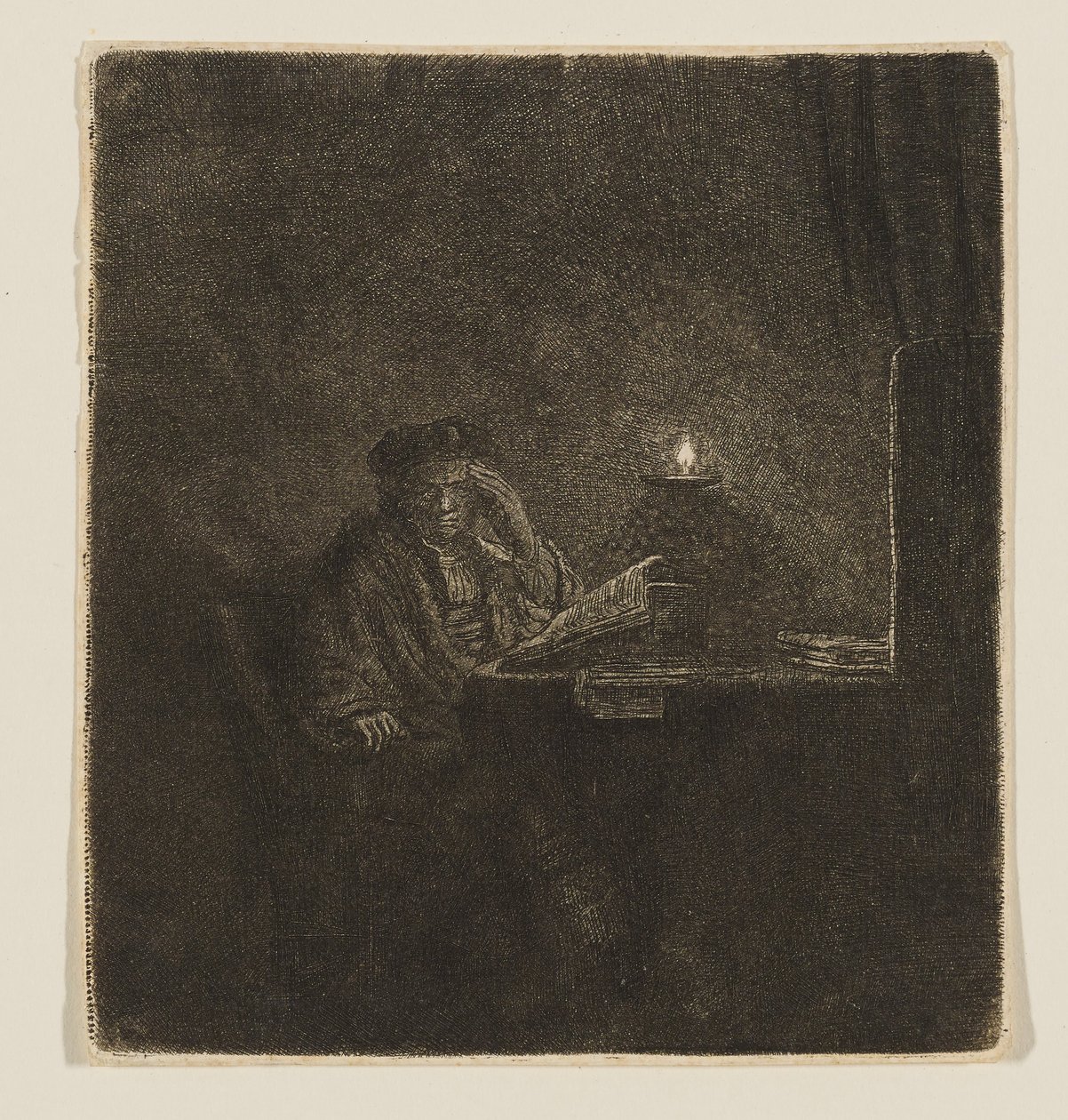 Student vid ett bord i stearinljusets sken av Rembrandt van Rijn