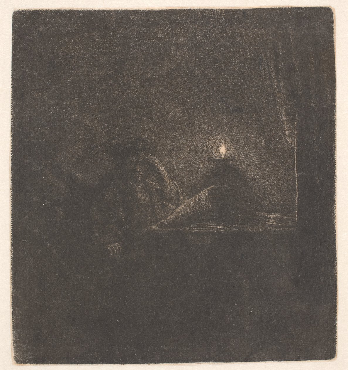 En student vid ett bord i stearinljusets sken av Rembrandt van Rijn